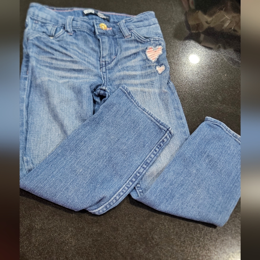 Size 5 Levi jeans with sparkly heart embellishment.
